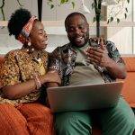 Couple talking while sitting on couch