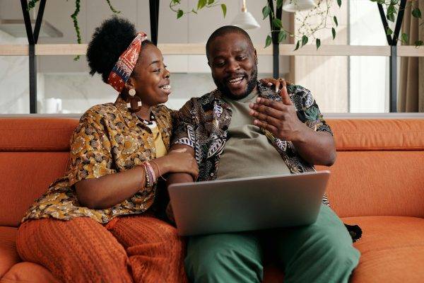 Couple talking while sitting on couch